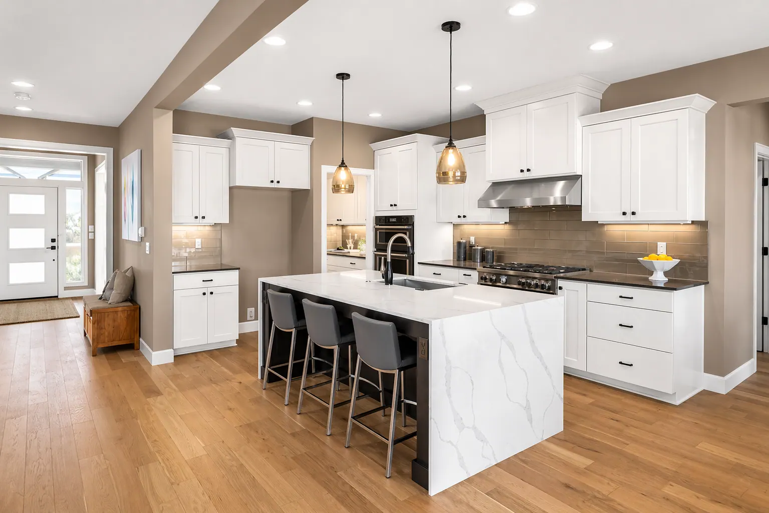 Kitchen: A bright kitchen built around an island, with seating where people gather.